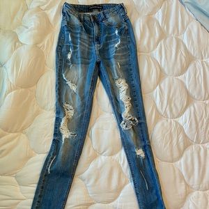Distressed ripped baby blue jeans